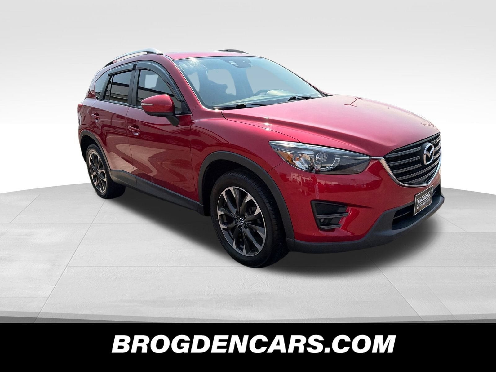 2016 Mazda Mazda CX-5 Grand Touring in Soul Red Metallic — front three-quarter view
